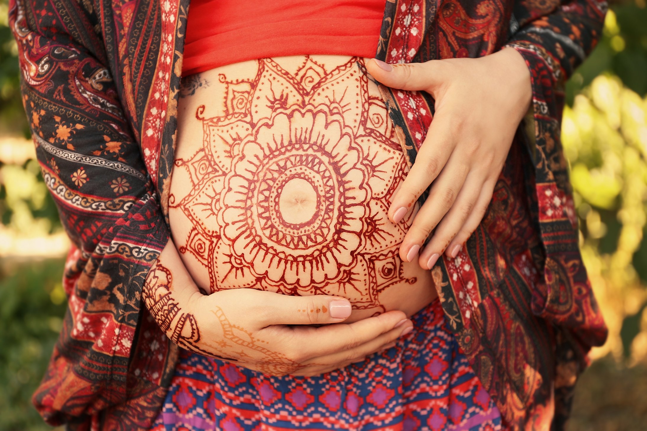 Young Pregnant Woman with Henna Tattoo on Belly